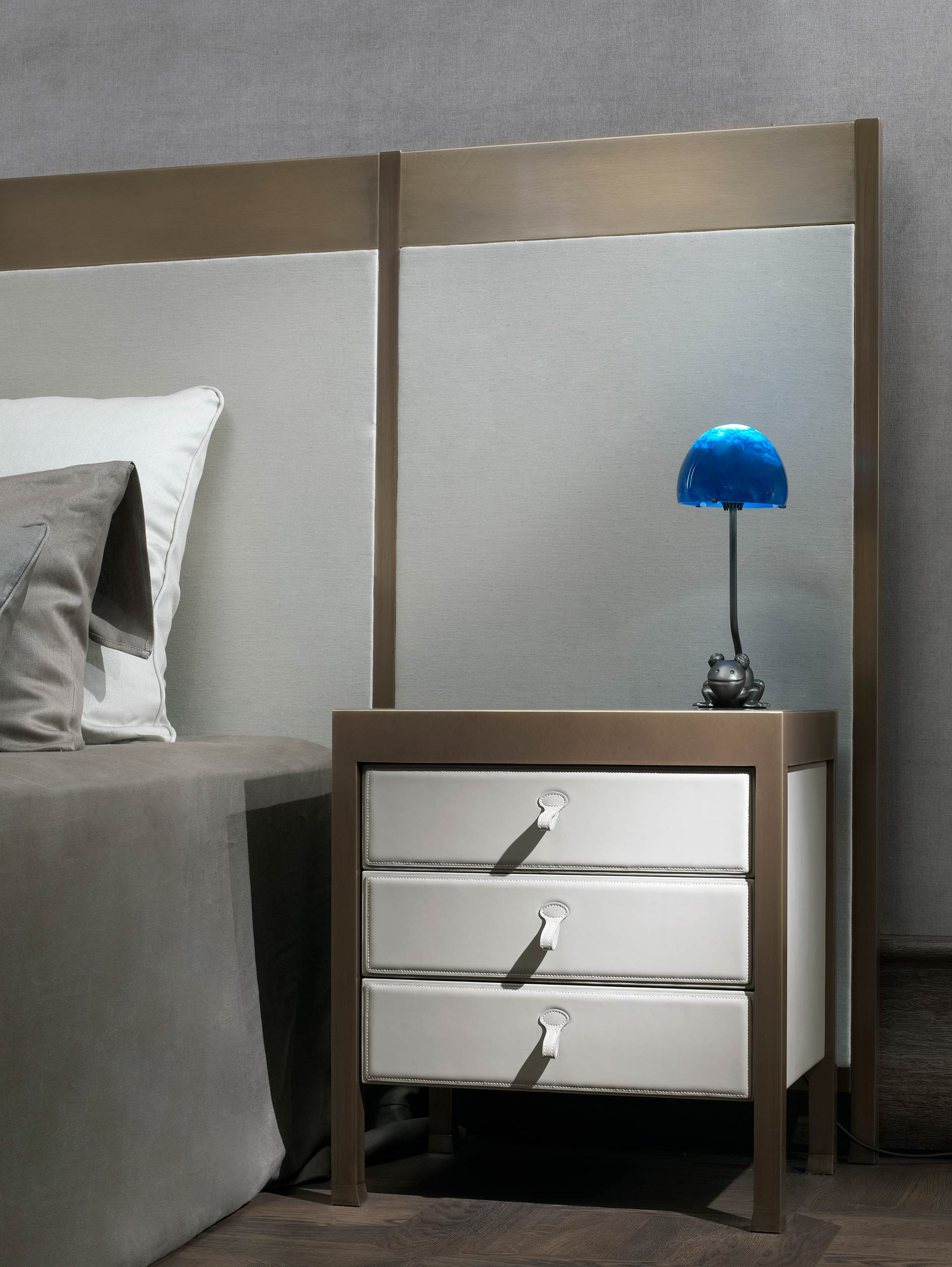 Gong is a bronze bedside table that can be covered in fabric or leather, from the Promemoria's catalogue | Promemoria
