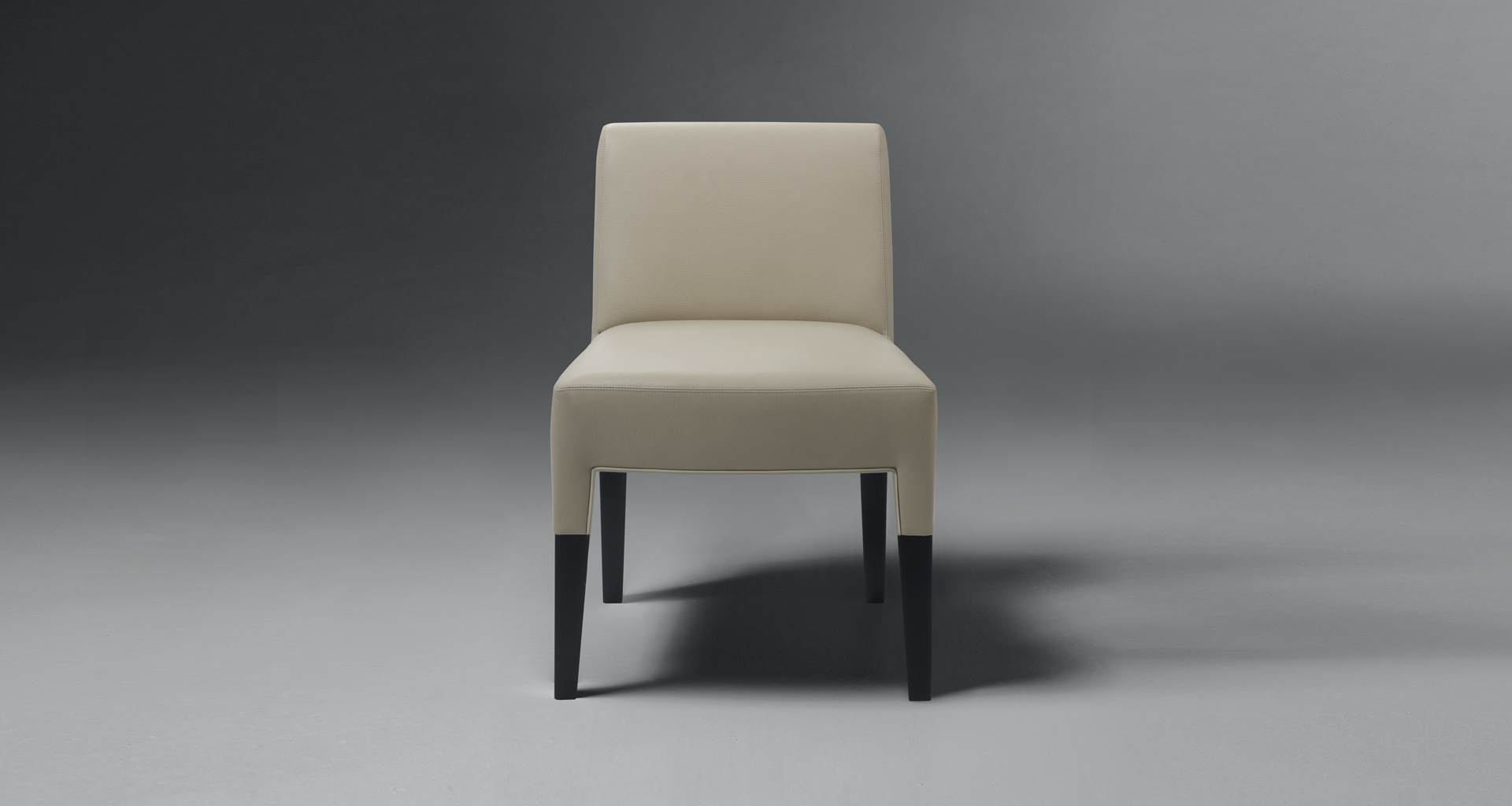 Brigitta Short is a wooden dining chair covered in fabric or leather, with a handle on the backrest, from Promemoria's catalogue | Promemoria