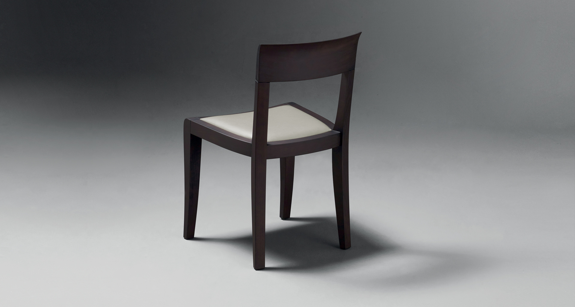 High-back detail of Eloise, a wooden dining chair with leather seat, available with or without armrests from Promemoria's catalogue | Promemoria