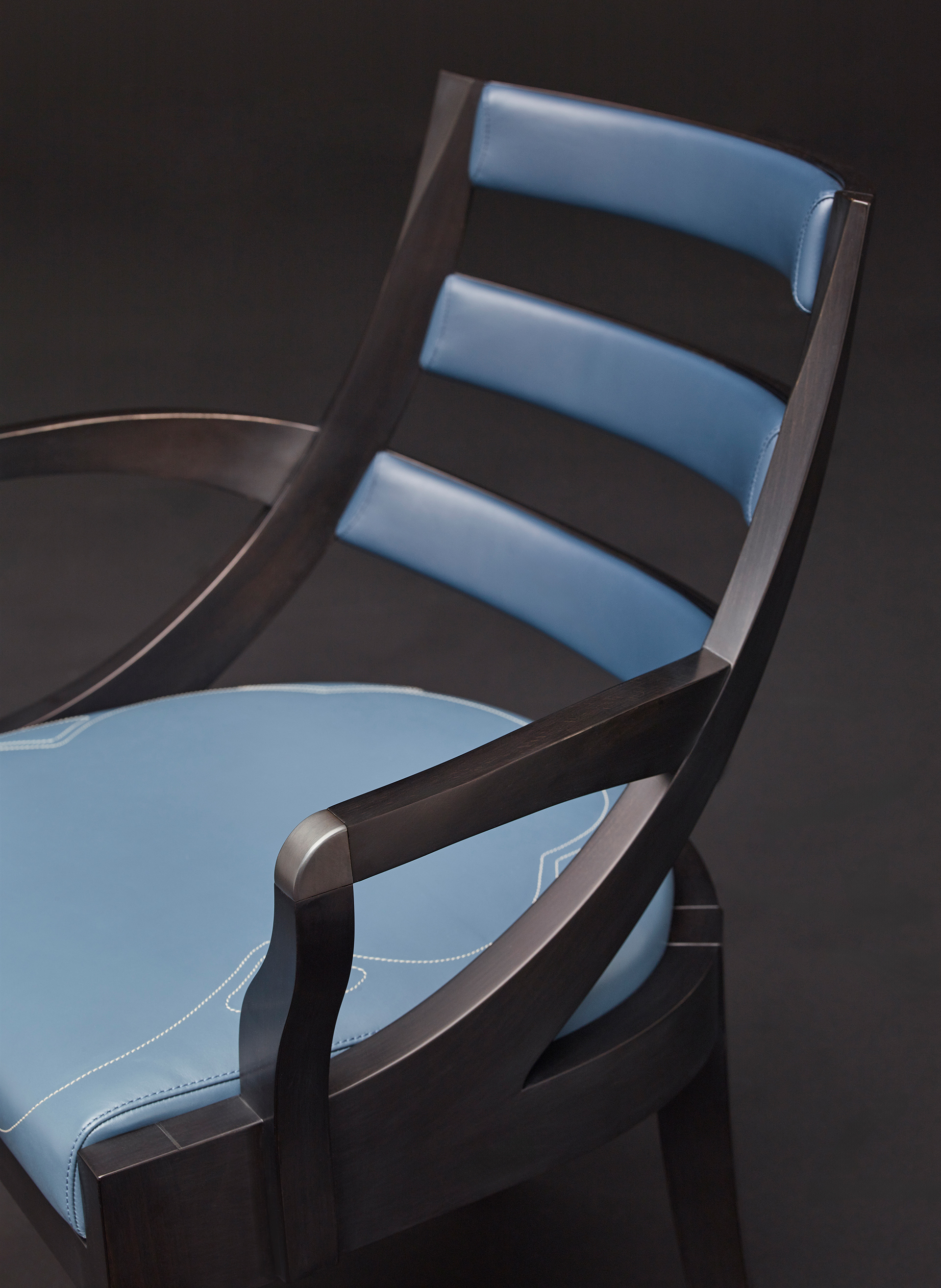 Judith is a wooden dining chair with a bronze detail on the armrest, from Promemoria's catalogue | Promemoria