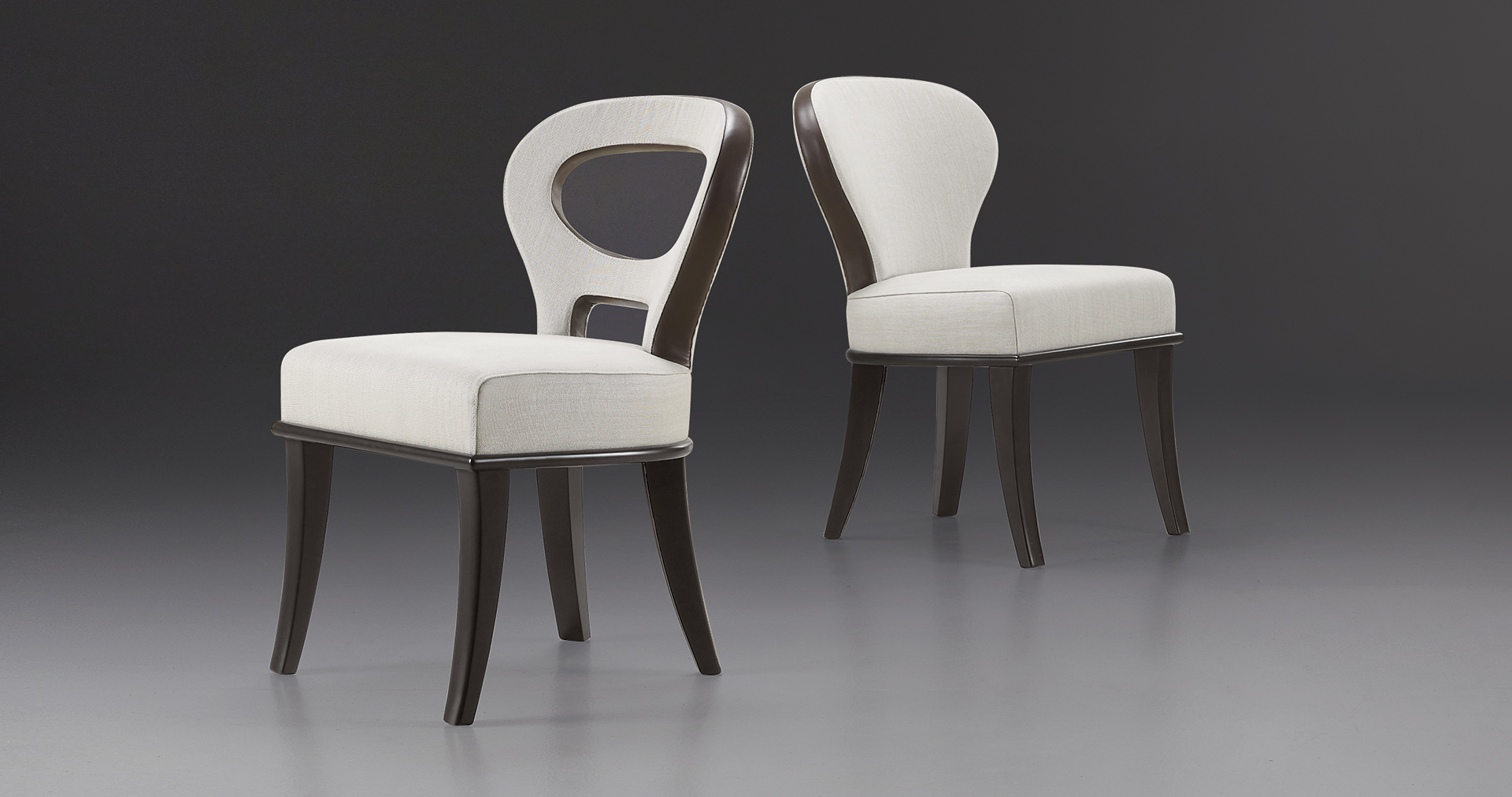 Moka e Roka are two wooden chairs covered in fabric and leather, with or without bronze armrests, from Promemoria's catalogue | Promemoria