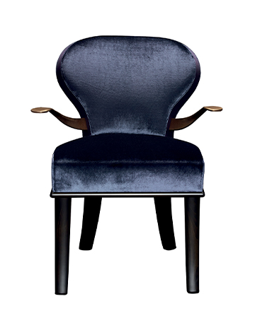 Moka e Roka are two wooden chairs covered in fabric and leather, with or without bronze armrests, from Promemoria's catalogue | Promemoria