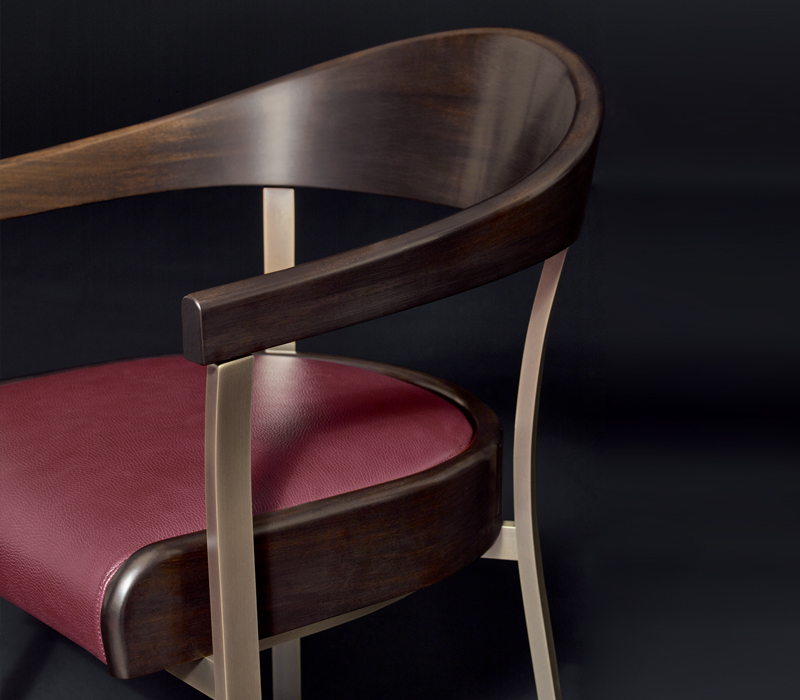 Detail of Rachele, a bronze chair with arms with wooden or leather back and leather seat, from Promemoria's catalogue | Promemoria