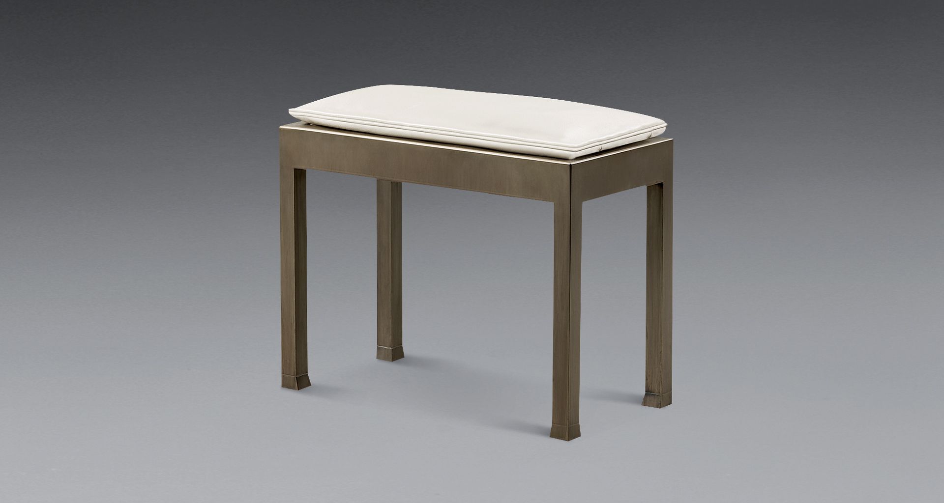 Gong is a bronze stool with a leather cushion, from Promemoria's catalogue | Promemoria