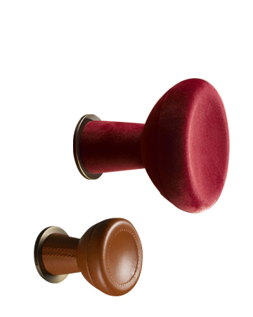 Bottone is a fabric or leather wall hanger shaped like a button, from Promemoria's catalogue | Promemoria