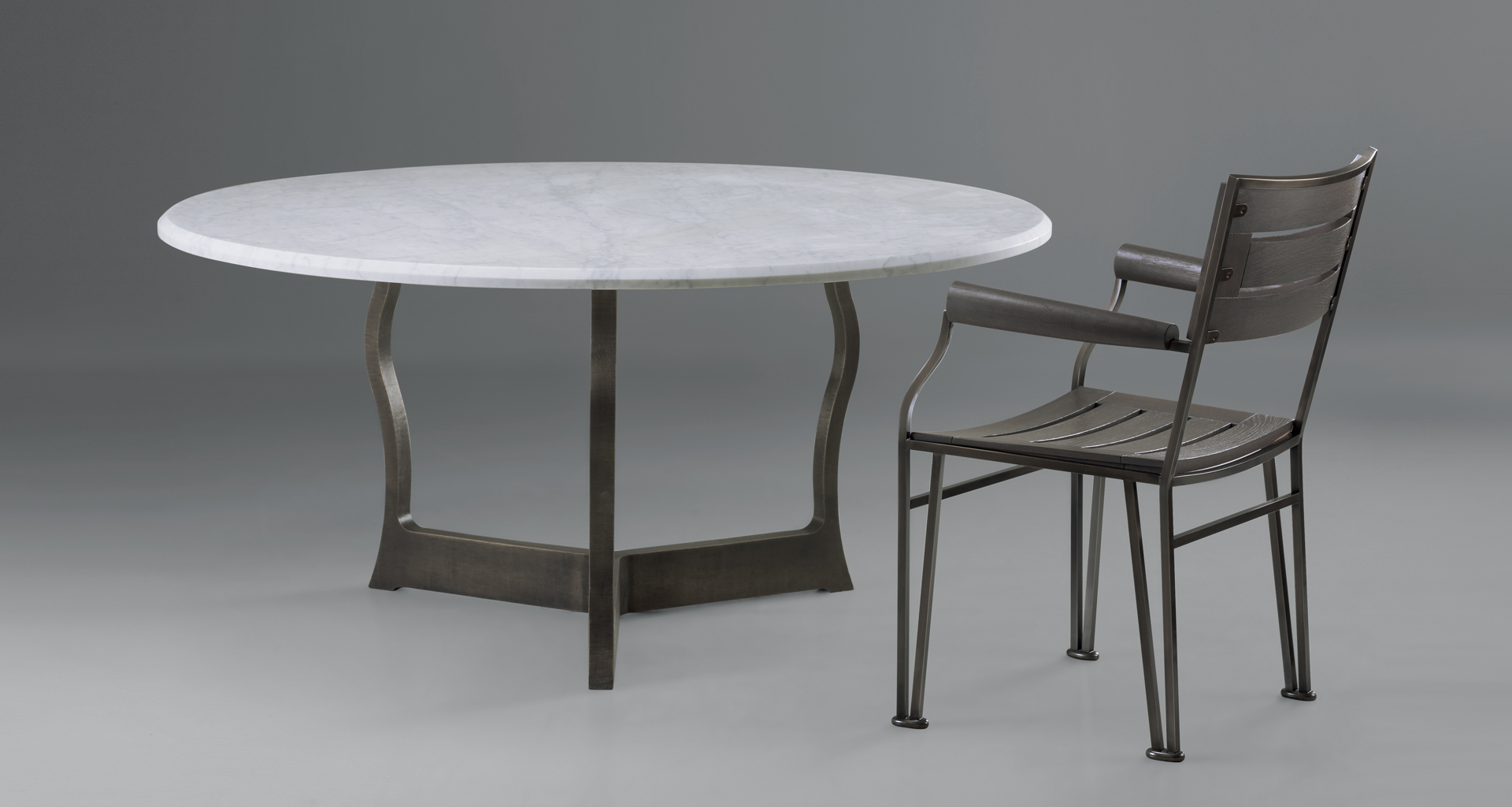 Erasmo is an outdoor dining table with bronze base and marble top, from Promemoria's outdoor catalogue | Promemoria
