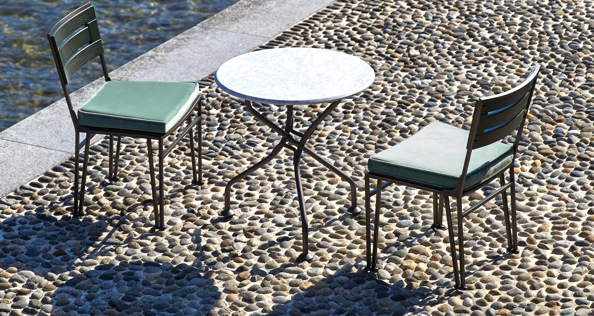 Cernobbio is an outdoor small table with bronze base and marble top, from Promemoria's outdoor catalogue | Promemoria
