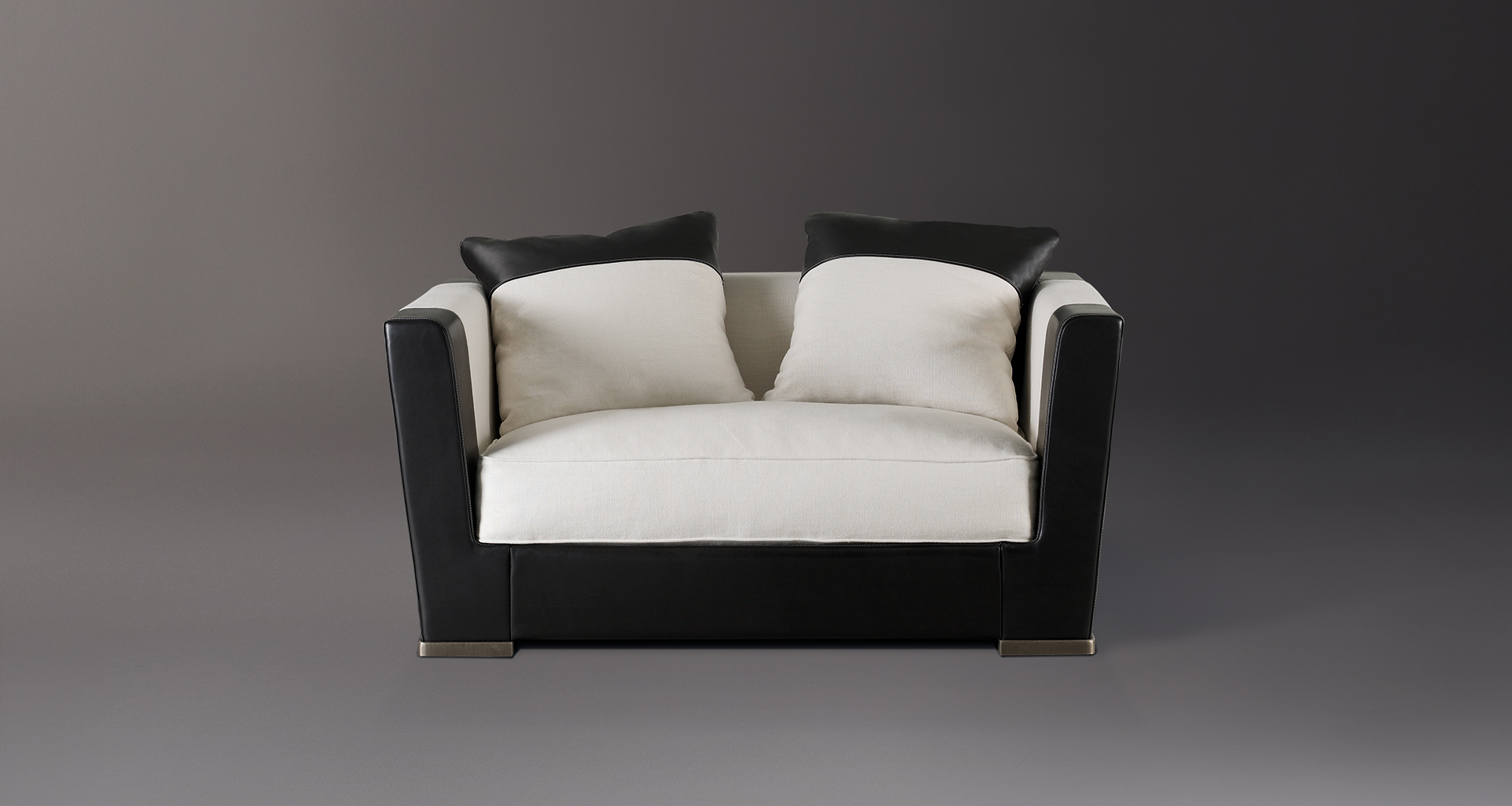 Dolce Vita is a sofa covered in fabric with leather details and bronze feet, from Promemoria's catalogue | Promemoria