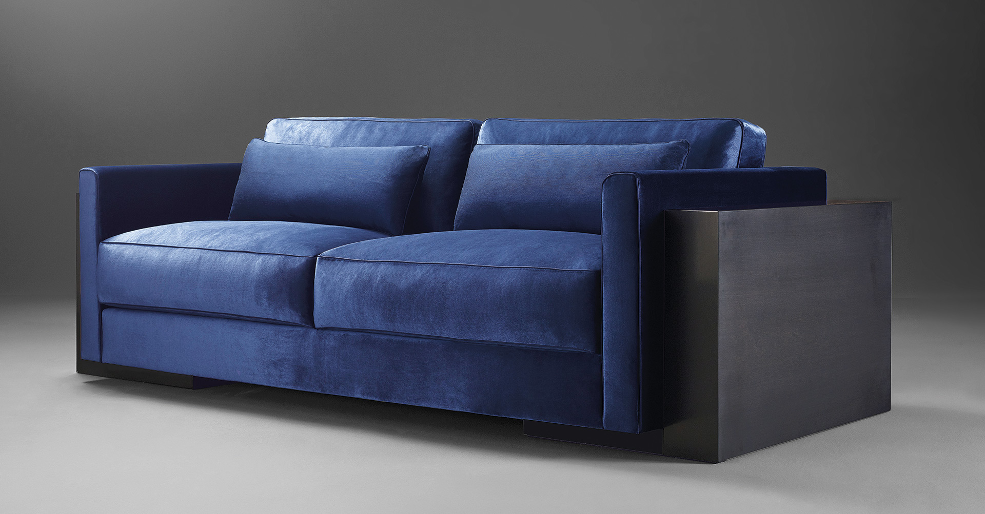 Ipparco is a wooden sofa with seat and back cushions in fabric, from Promemoria's Amaranthine Tales collection | Promemoria
