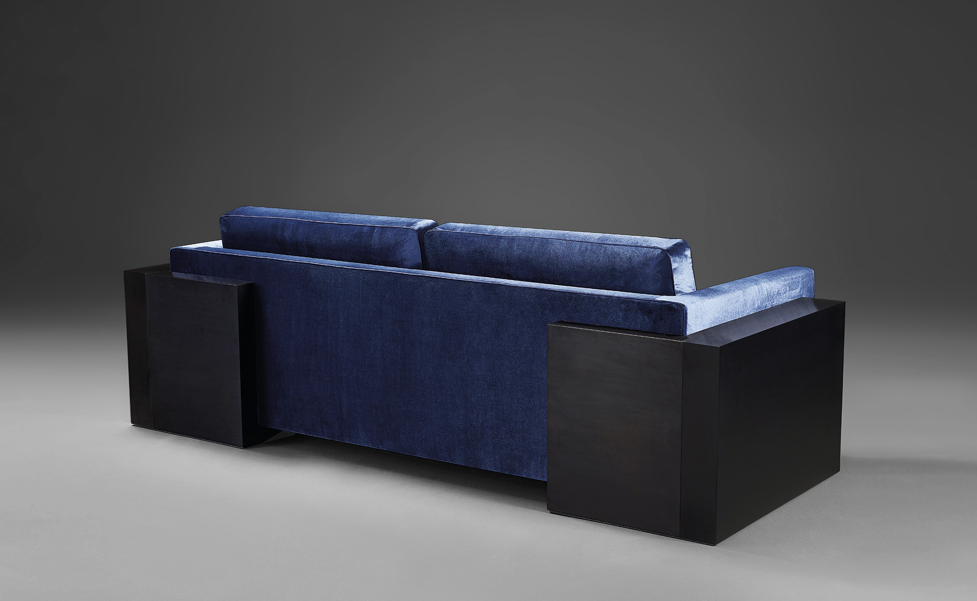 Ipparco is a wooden sofa with seat and back cushions in fabric, from Promemoria's Amaranthine Tales collection | Promemoria