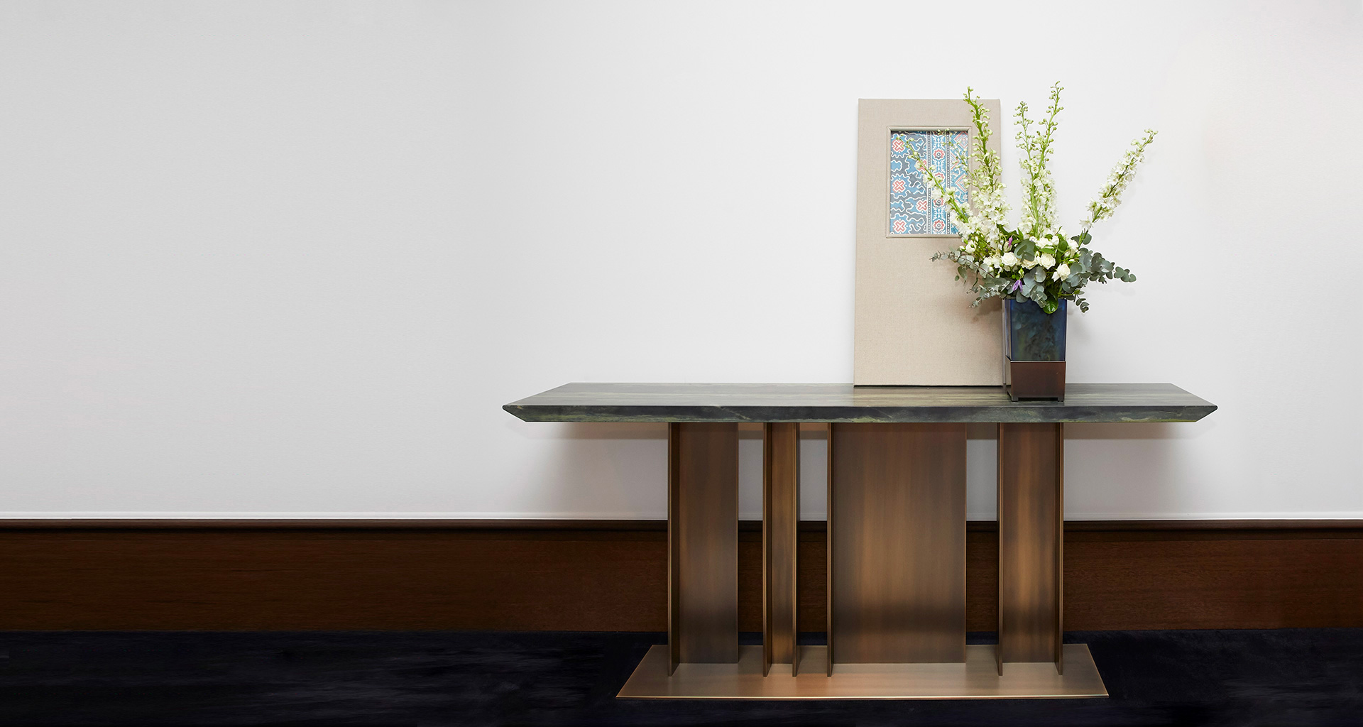 Nila is a console with bronze base and wooden top, from Promemoria's Indigo Tales collection | Promemoria