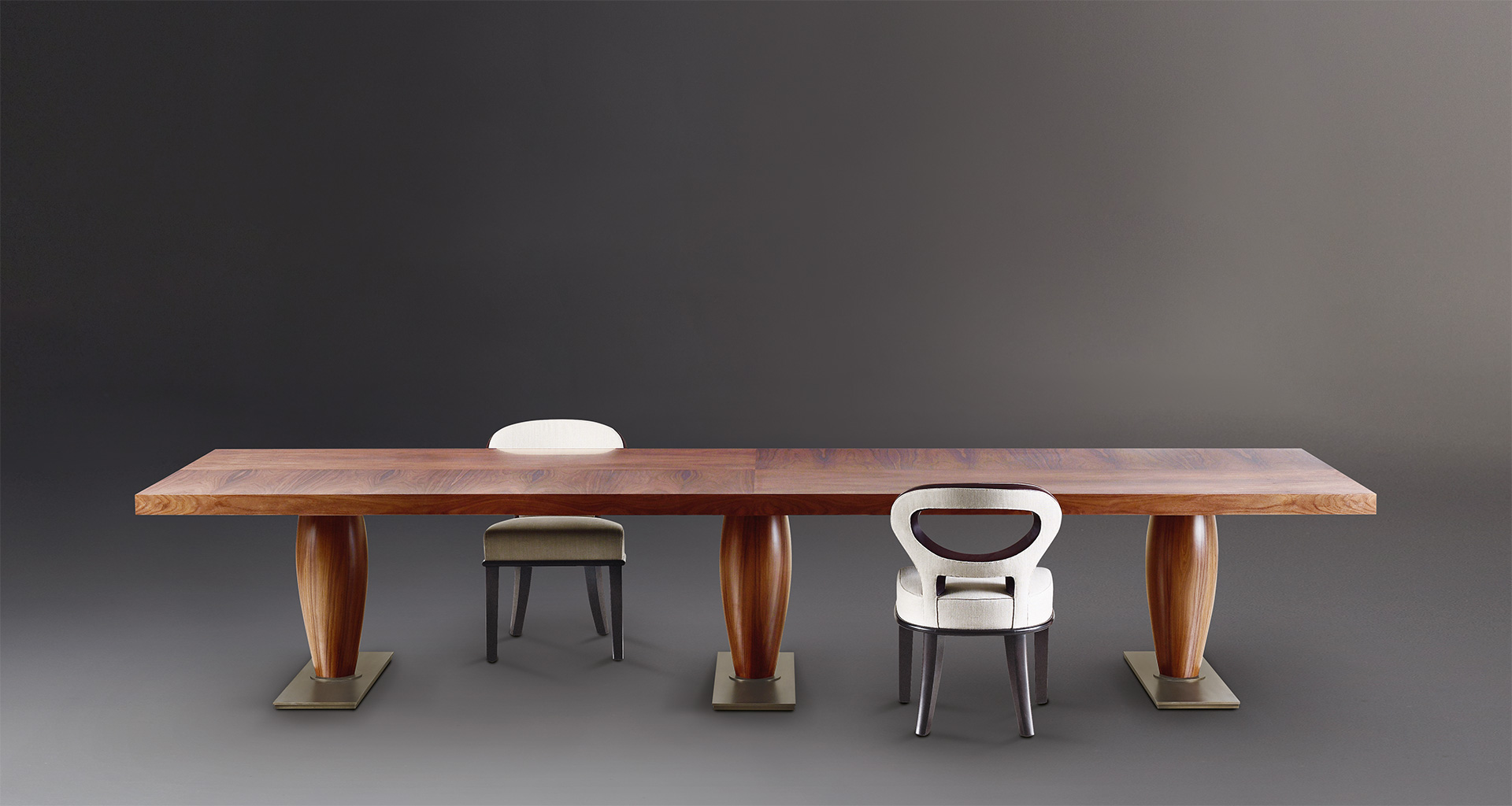 Bassano is an impressive wooden dining table with a bronze base available with inlaid top, from Promemoria's catalogue | Promemoria